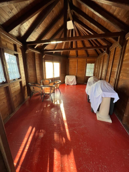 Interno chalet location matrimoni con pavimento rosso e arredo generico senza identità tematica
